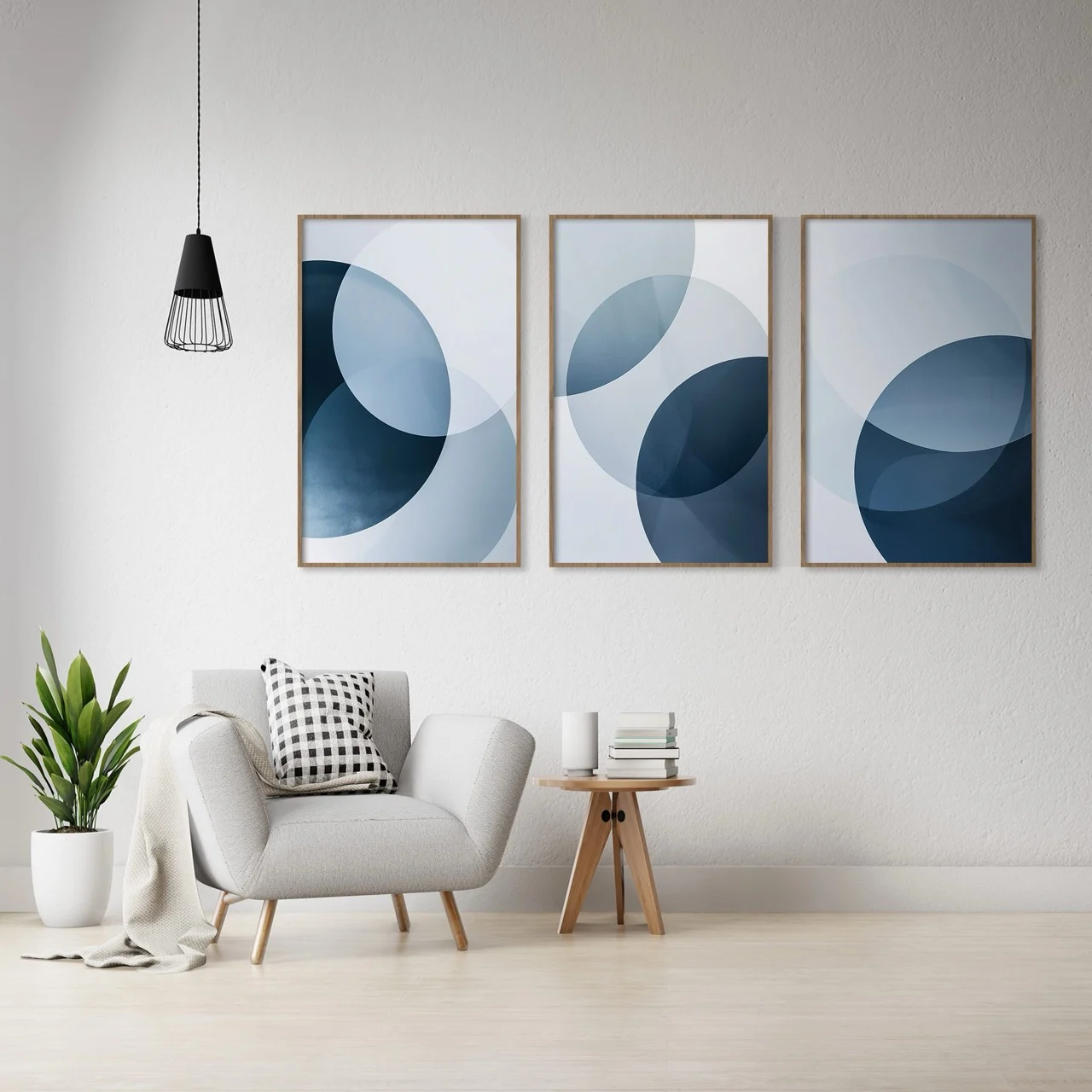 Blue Abstract Wall Art Triptych — Reading Corner Three blue and white geometric abstract prints above a grey armchair in a light room.